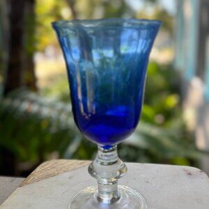 Sapphire blue footed drinking glass (8″ tall, used, hand-blown glass tumbler)